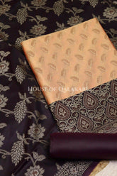 Banarasi Unstitched Dress Material in apricot beige and with all over leaf buti and resham border along with floral resham jaal dupatta – product