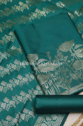 Banarasi silk Unstitched Dress Material in Emerald Green and with lotus floral border and diagonal striped zari work dupatta – product