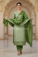Banarasi Silk Unstitched Dress Material in Sage Green and Green contrast with Intricate Zari Buti – festive pose