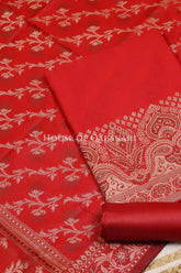 Banarasi Unstitched Dress Material in Red and with plain body and resham border and diagonally striped resham dupatta – product