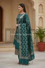 Banarasi Chanderi Cotton Unstitched Dress Material in Bottle Green and with matching floral vine jaal dupatta – side pose