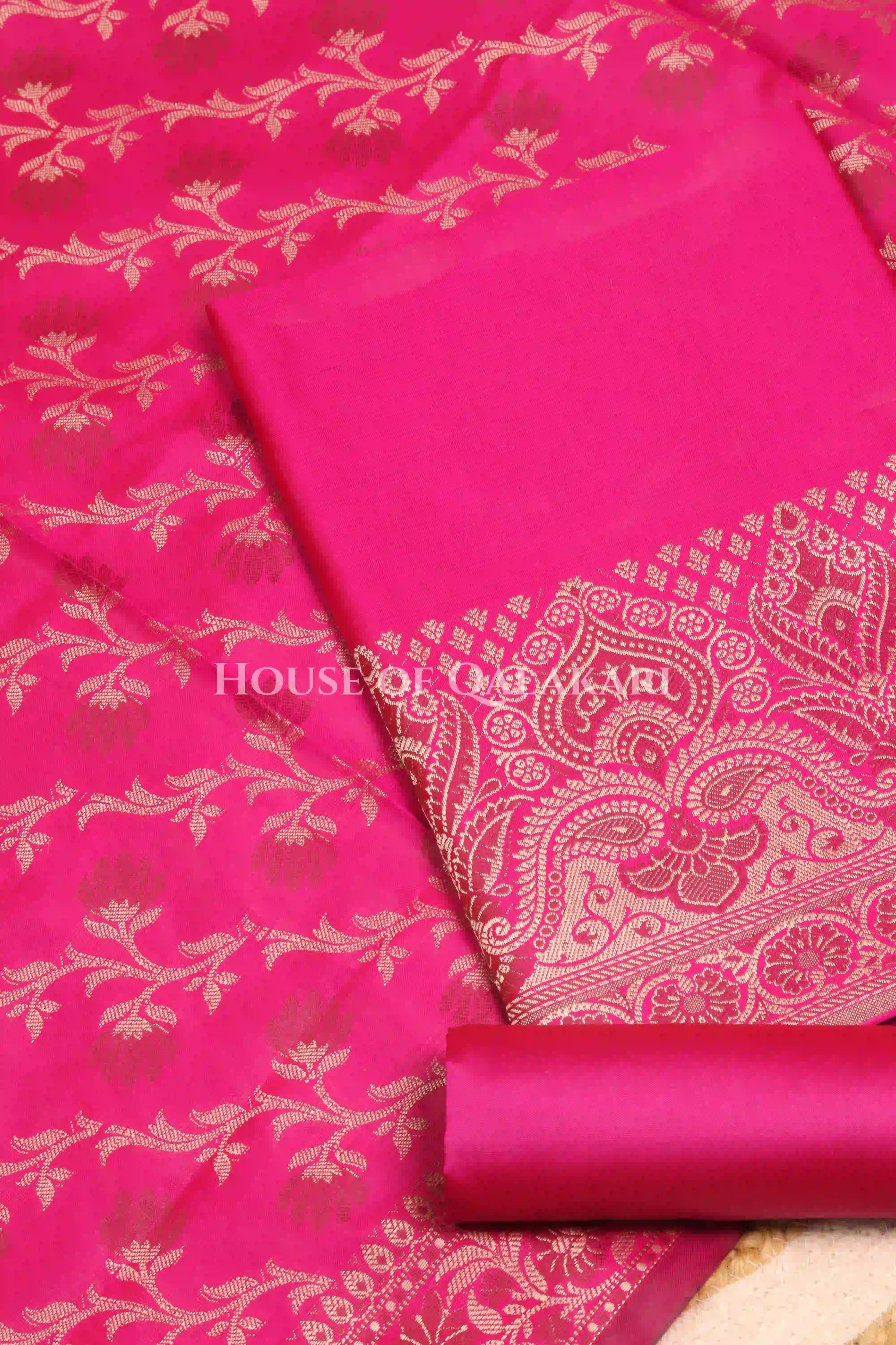 Banarasi Unstitched Dress Material in Rani Pink and with plain body and resham border and diagonally striped resham dupatta – product