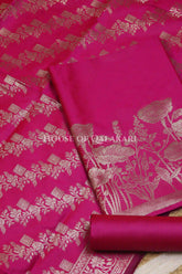 Banarasi silk Unstitched Dress Material in Rani Pink and with lotus floral border and diagonal striped zari work dupatta – product