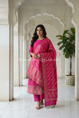 Banarasi Unstitched Dress Material in Rani Pink and with plain body and resham border and diagonally striped resham dupatta – front pose