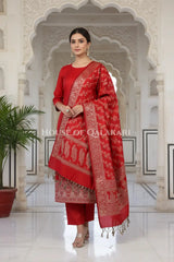 Banarasi Unstitched Dress Material in Red and with plain body and resham border and diagonally striped resham dupatta – front pose