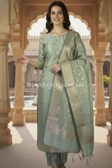 Banarasi Cotton Silk blend Unstitched Dress Material in Antique Aqua green colour with Intricate Zari Diamond Buti – festive pose