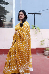 Mustard Bagru Mulmul cotton Saree with Off-White Prints