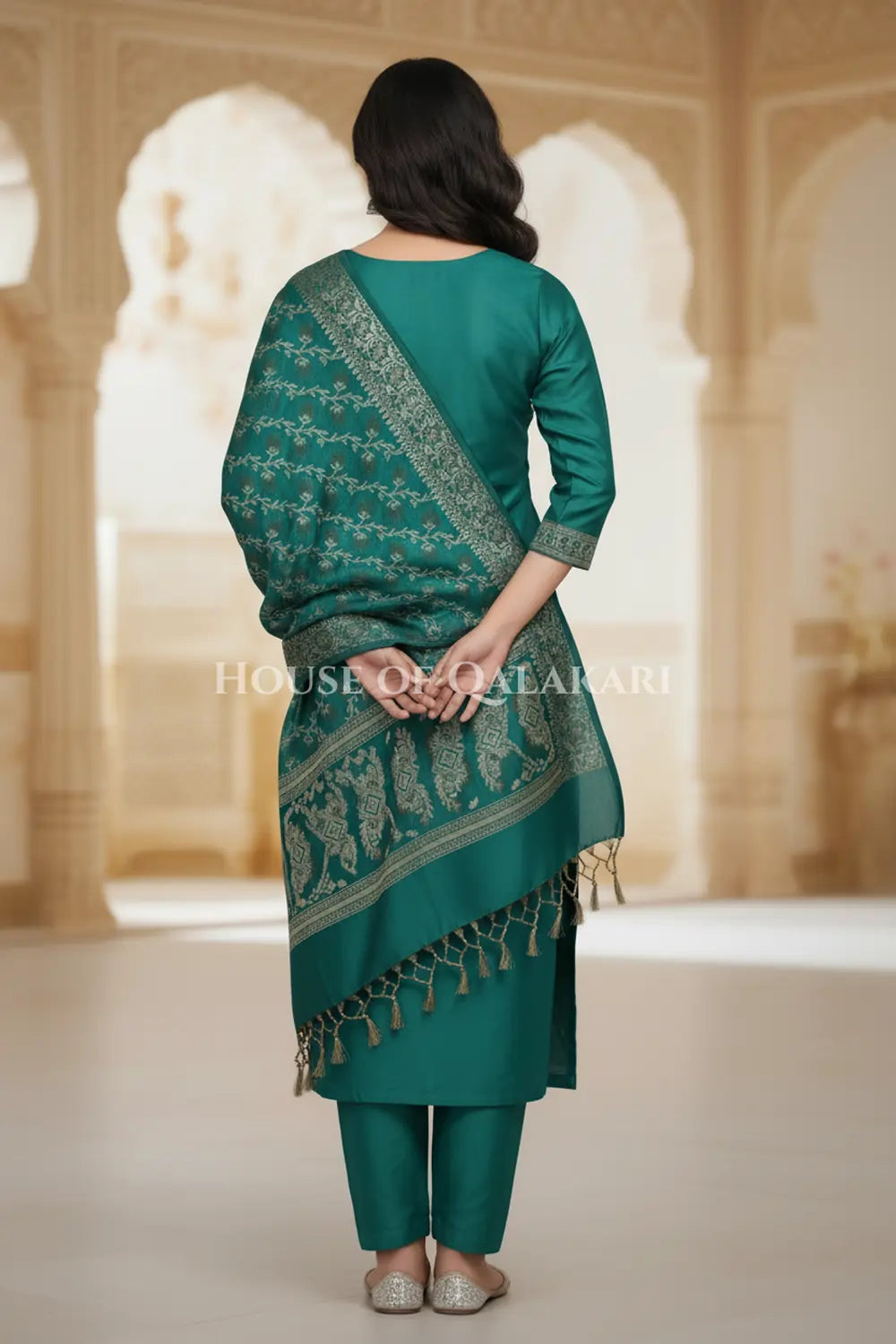 Banarasi Unstitched Dress Material in Emerald Green and with plain body and resham border and diagonally striped resham dupatta – back pose