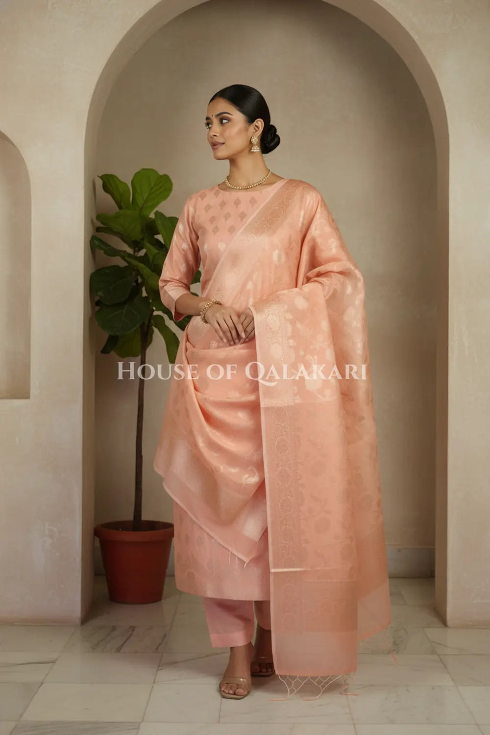 Banarasi Chanderi Cotton Unstitched Dress Material in Peach Pink with intricate Zari Buti work – side pose