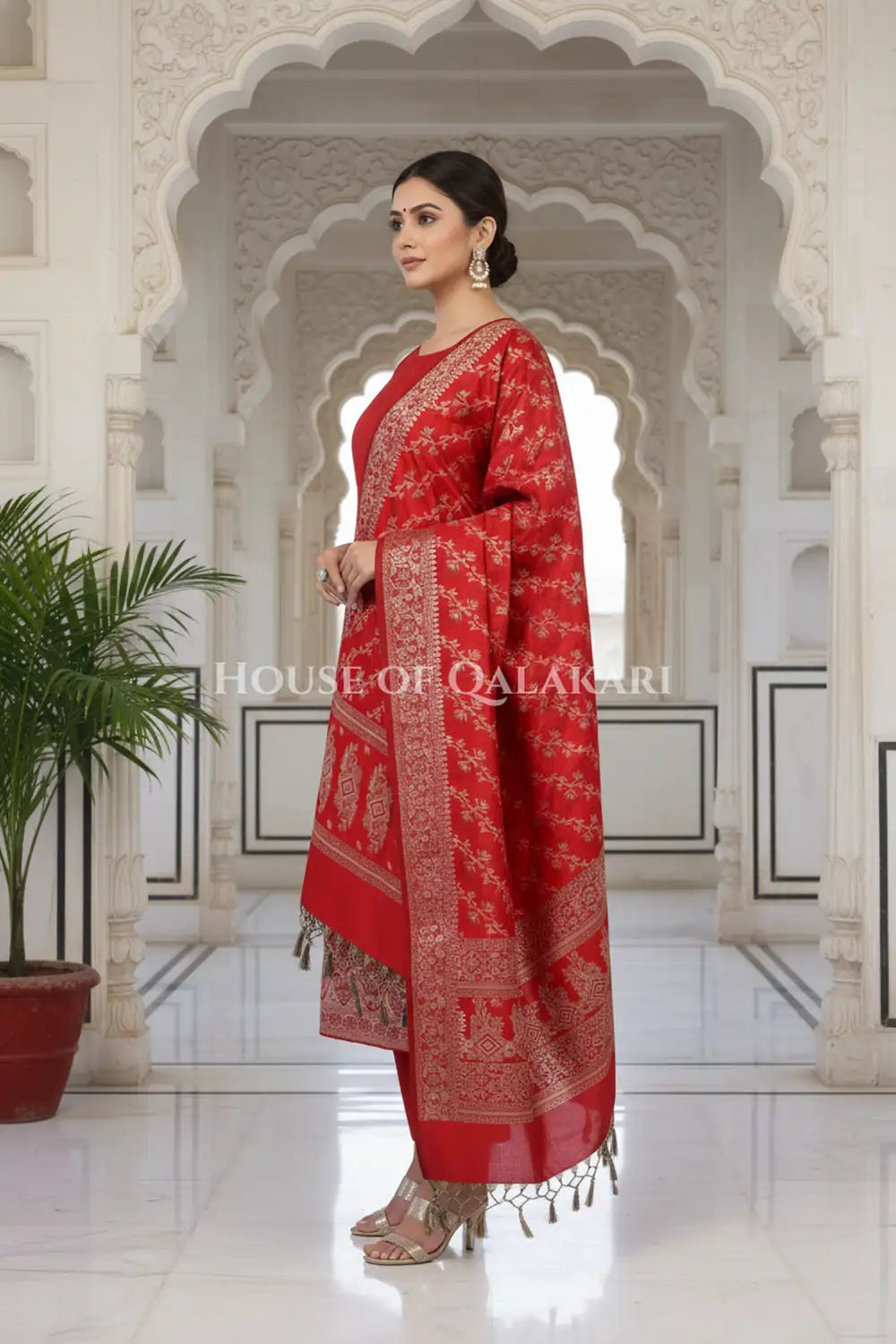 Banarasi Unstitched Dress Material in Red and with plain body and resham border and diagonally striped resham dupatta – side pose