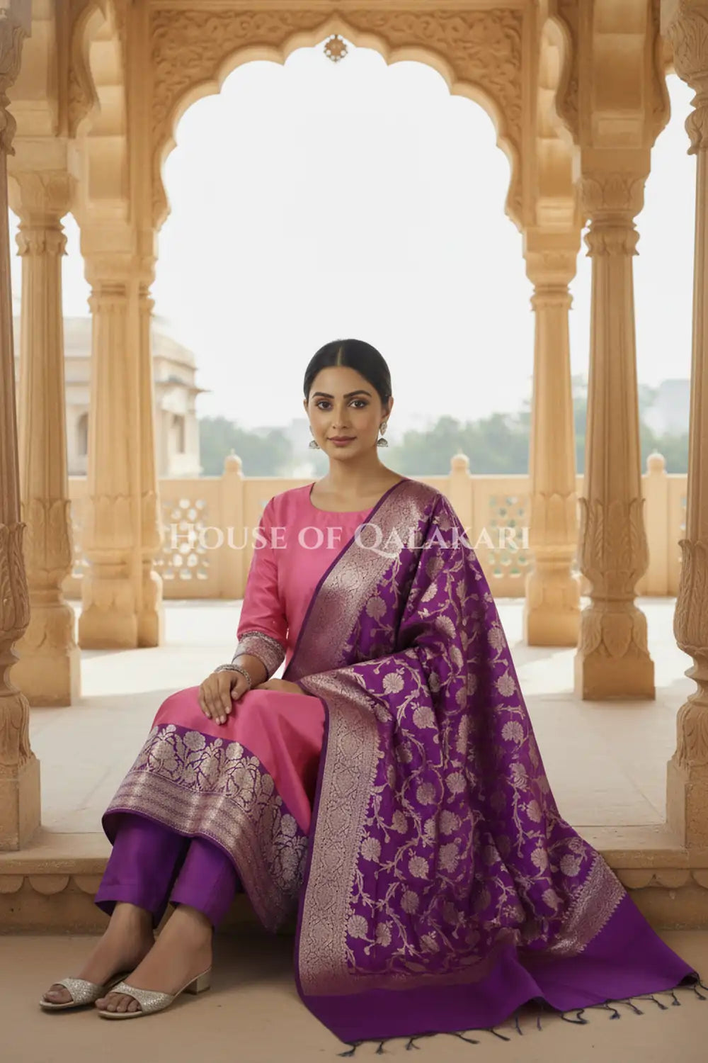Banarasi silk Unstitched Dress Material in Rose Pink and Dark Purple contrast with Intricate Zari Buti – sitting pose