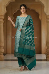 Banarasi Silk Unstitched Dress Material in Blue Grey and Deep Bluish Green contrast with Intricate Zari Buti – festive pose