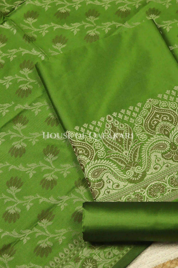 Banarasi Unstitched Dress Material in Light Olive Green and with plain body and resham border and diagonally striped resham dupatta – product