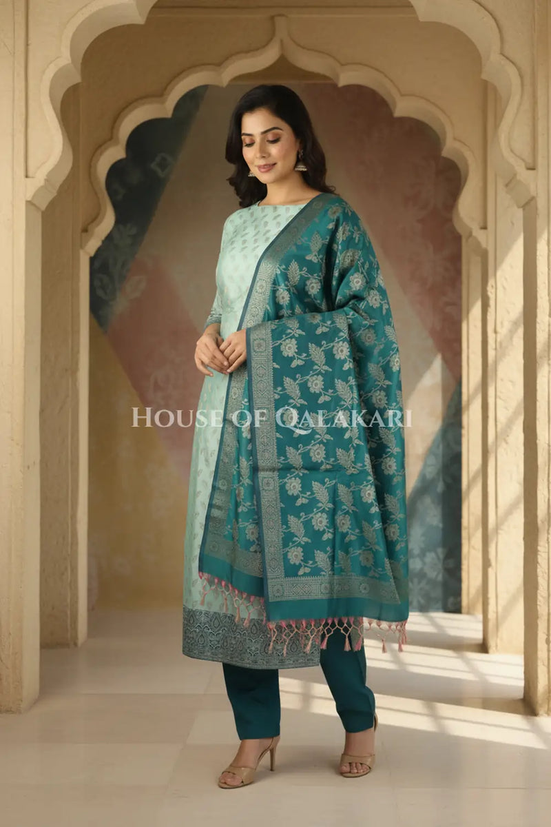 Banarasi Unstitched Dress Material in Silver Green and with all over leaf buti and resham border along with floral resham jaal dupatta – wedding pose