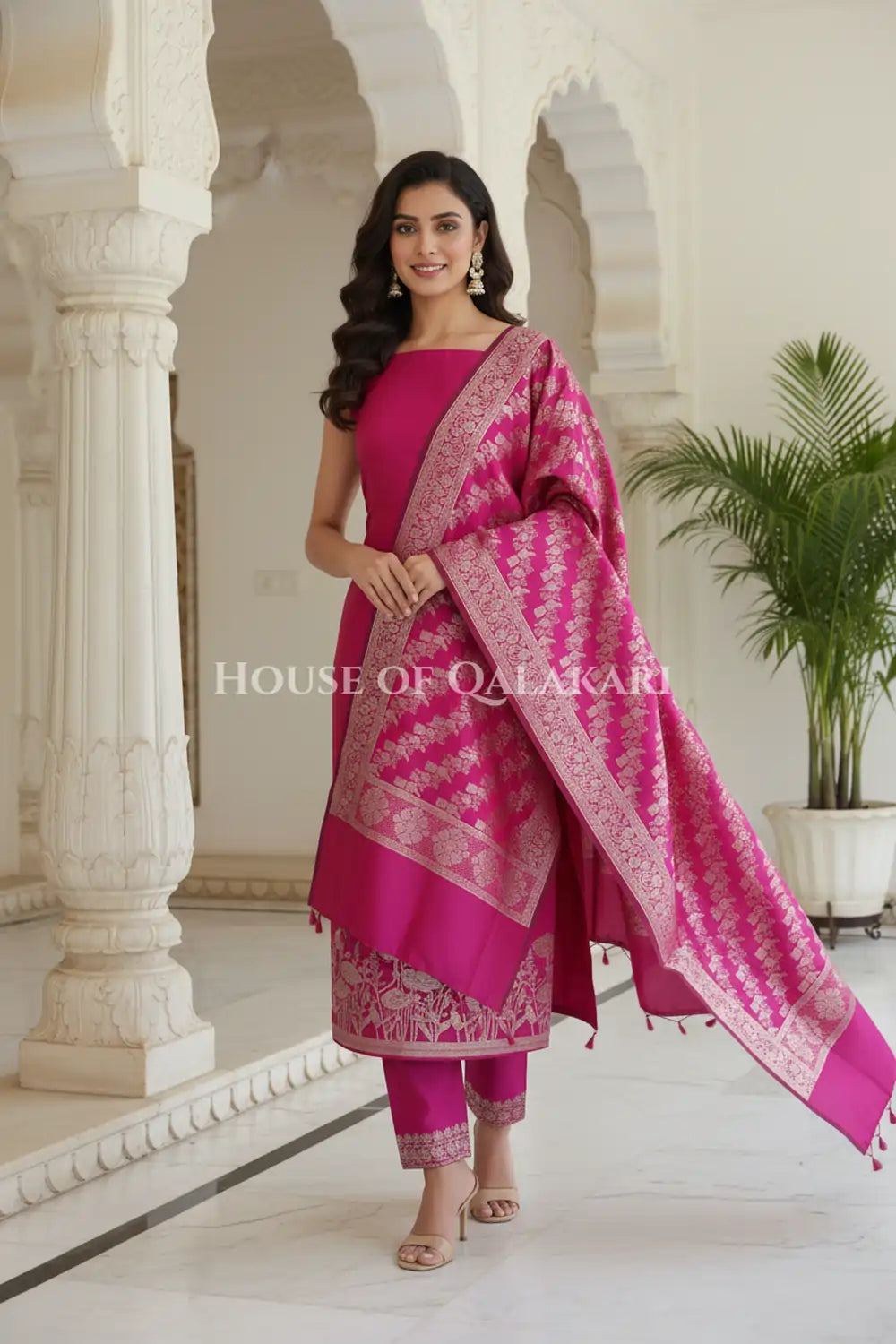 Banarasi silk Unstitched Dress Material in Rani Pink and with lotus floral border and diagonal striped zari work dupatta – festive pose
