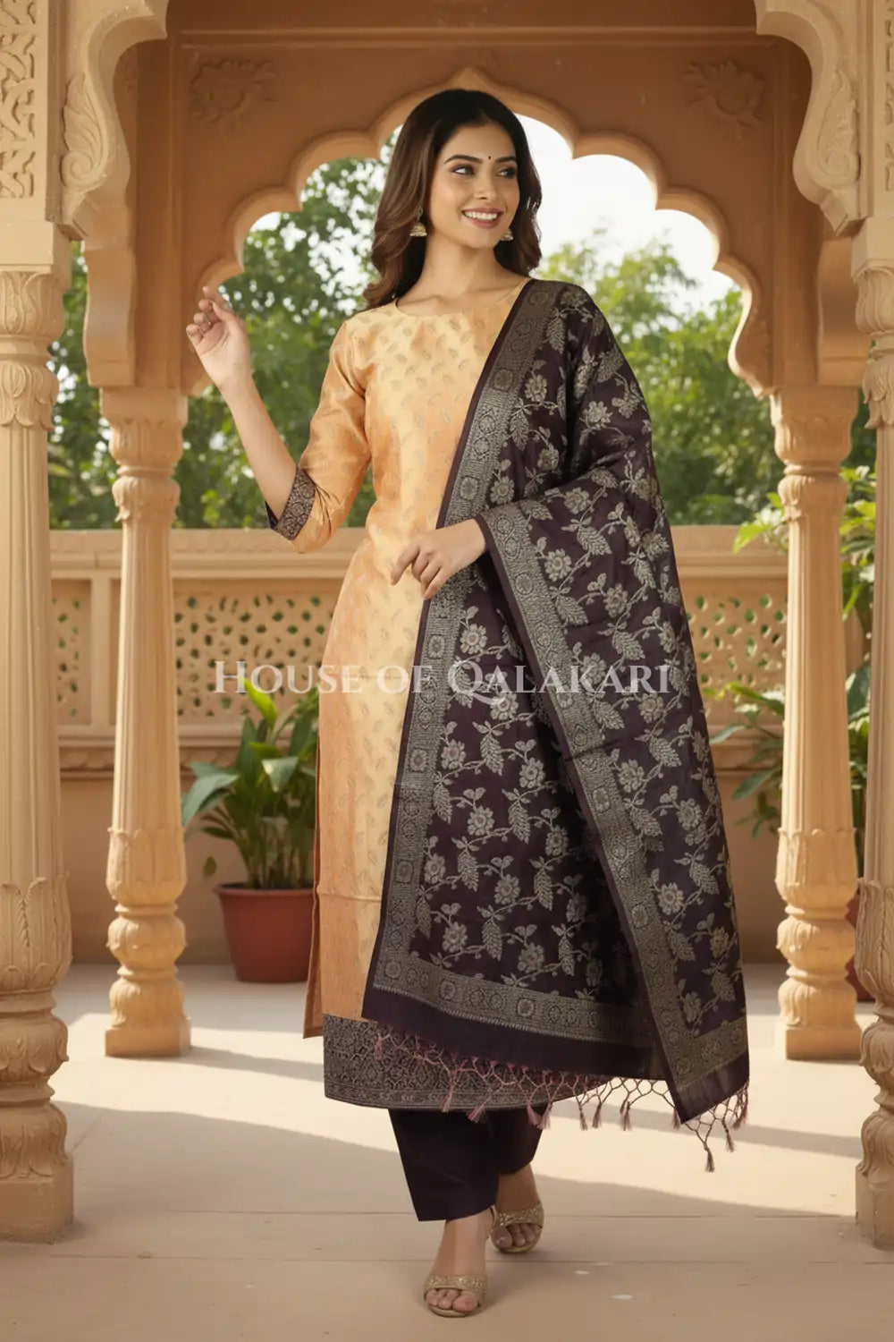 Banarasi Unstitched Dress Material in apricot beige and with all over leaf buti and resham border along with floral resham jaal dupatta – festive pose