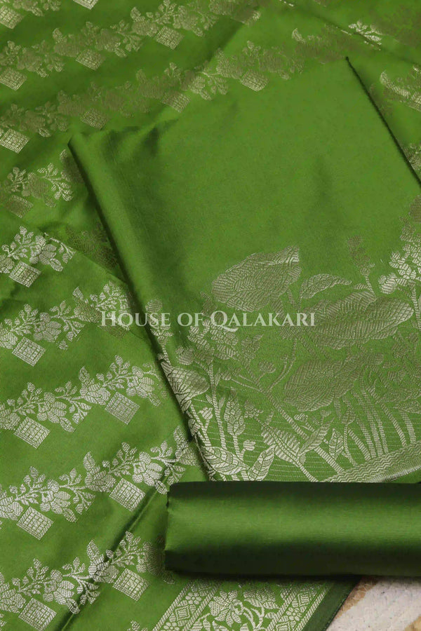 Banarasi silk Unstitched Dress Material in Light Olive Green and with lotus floral border and diagonal striped zari work dupatta – product