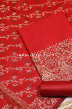 Banarasi Unstitched Dress Material in Red and with plain body and resham border and diagonally striped resham dupatta – product