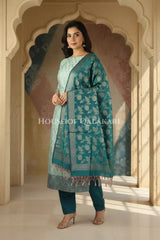 Banarasi Unstitched Dress Material in Silver Green and with all over leaf buti and resham border along with floral resham jaal dupatta – front pose
