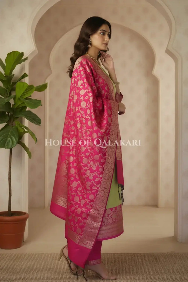 Banarasi silk Unstitched Dress Material in parrot green and pink contrast with Intricate Zari Buti – side pose