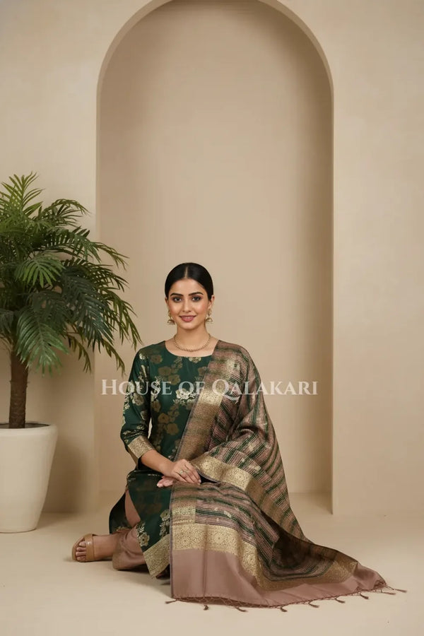 Banarasi Cotton Silk blend Unstitched Dress Material in deep emerald green and rose gold contrast with Intricate Zari Buti – sitting pose
