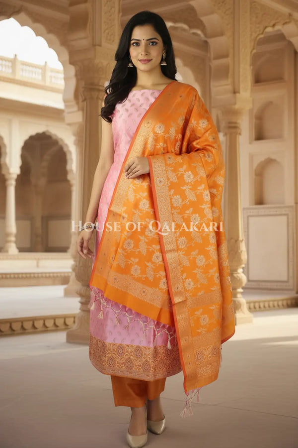 Banarasi Unstitched Dress Material in Dull Pink and with all over leaf buti and resham border along with floral resham jaal dupatta – front pose