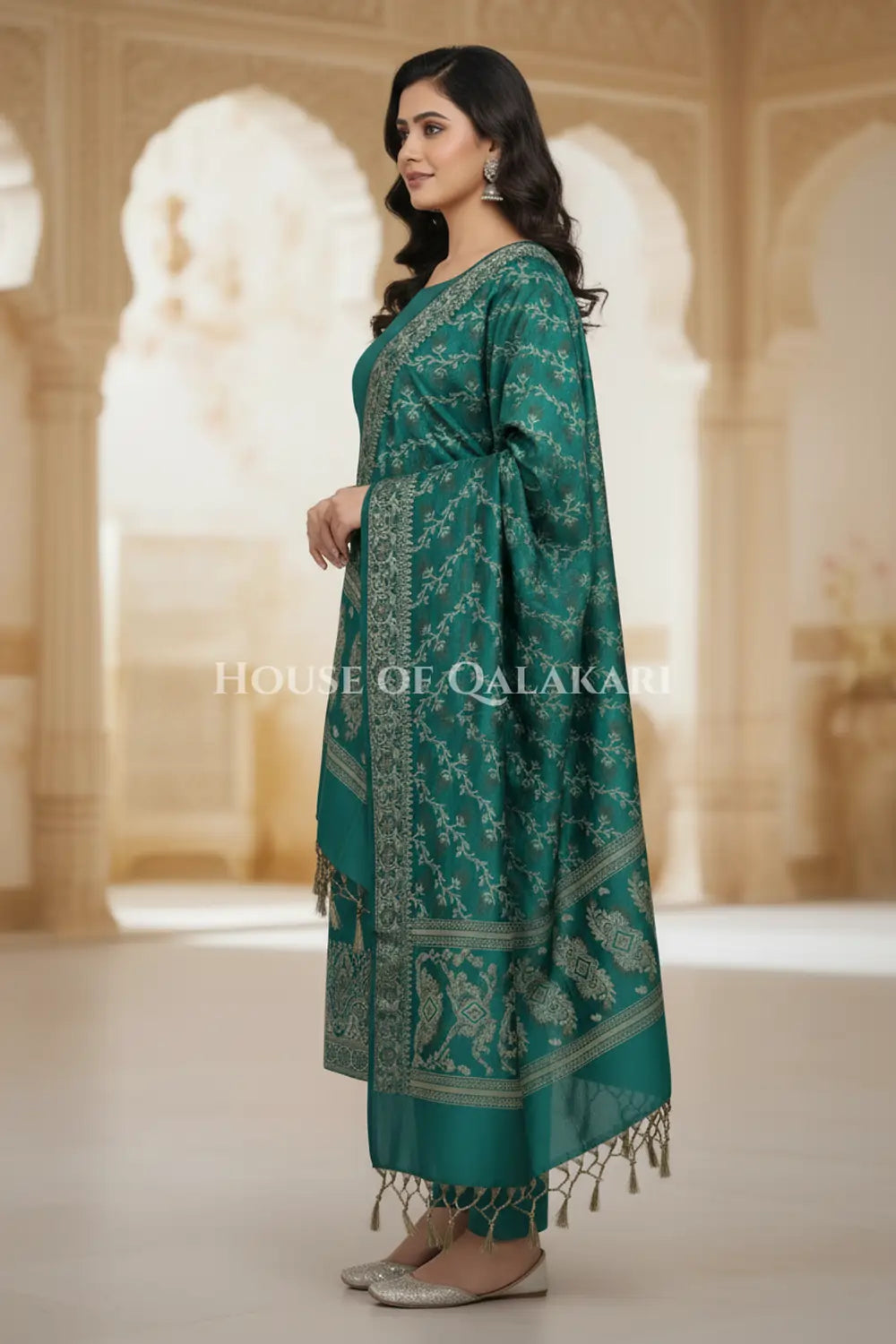 Banarasi Unstitched Dress Material in Emerald Green and with plain body and resham border and diagonally striped resham dupatta – side pose