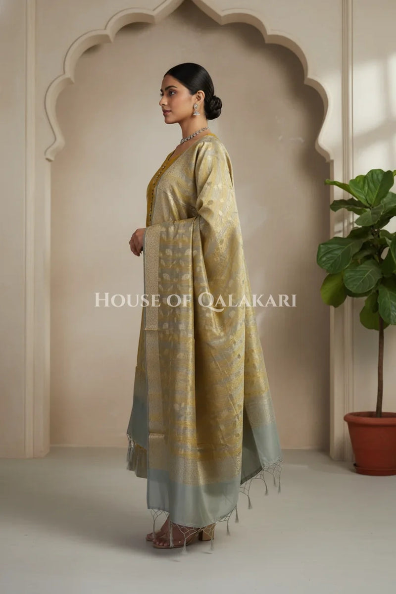 Banarasi Cotton Silk blend Unstitched Dress Material in mustard and silver grey contrast with Intricate Zari Buti – side pose