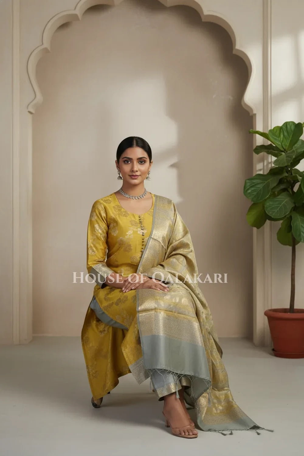 Banarasi Cotton Silk blend Unstitched Dress Material in mustard and silver grey contrast with Intricate Zari Buti – sitting pose
