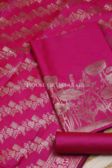 Banarasi silk Unstitched Dress Material in Rani Pink and with lotus floral border and diagonal striped zari work dupatta – product