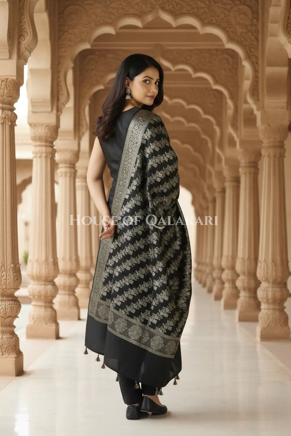 Banarasi silk Unstitched Dress Material in Black and with lotus floral border and diagonal striped zari work dupatta – back pose