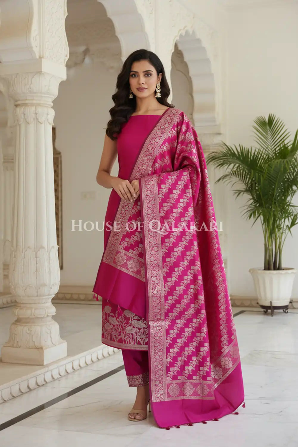 Banarasi silk Unstitched Dress Material in Rani Pink and with lotus floral border and diagonal striped zari work dupatta – front pose