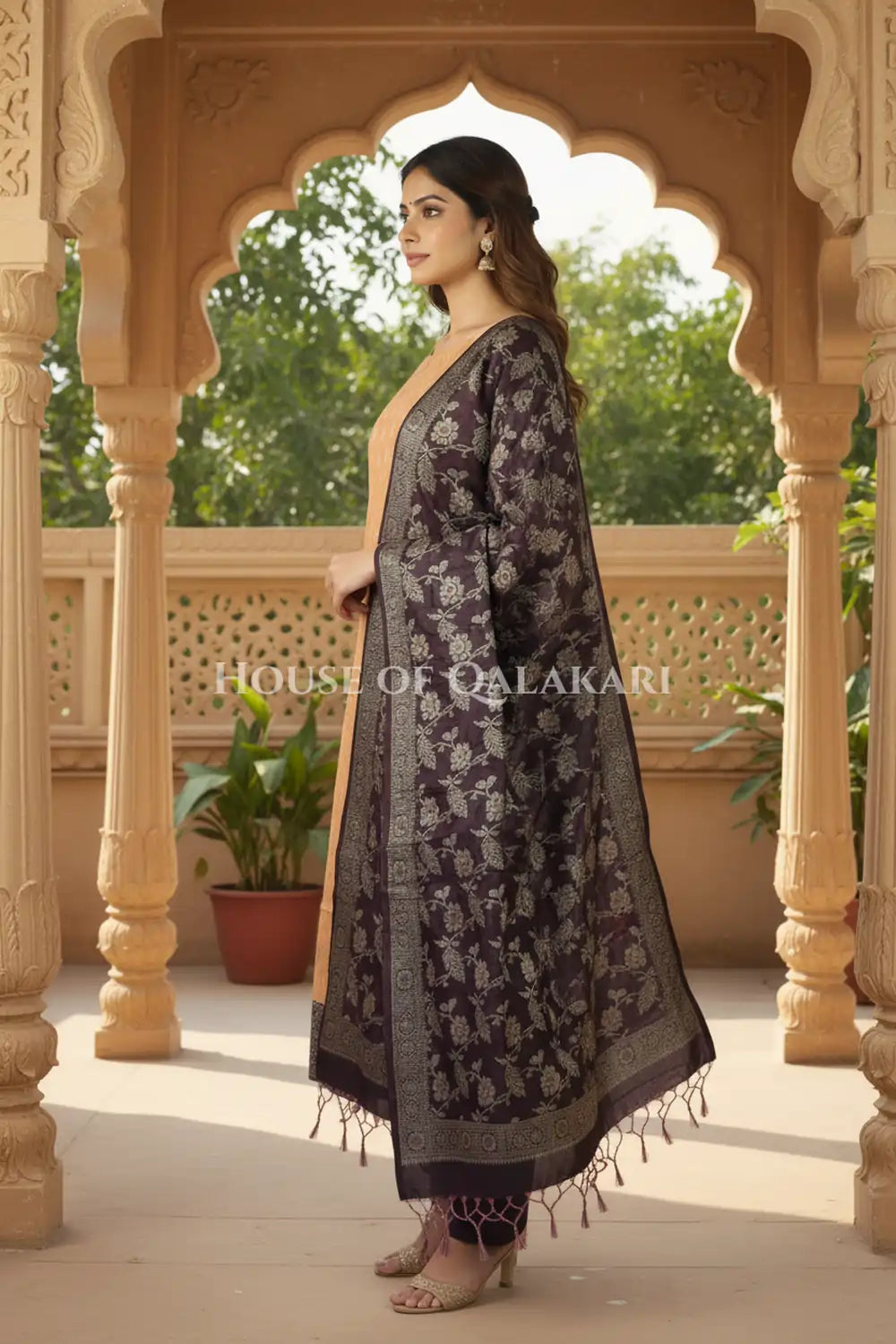 Banarasi Unstitched Dress Material in apricot beige and with all over leaf buti and resham border along with floral resham jaal dupatta – side pose
