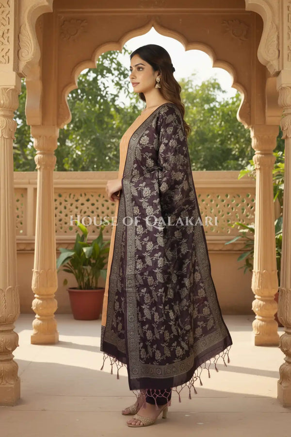 Banarasi Unstitched Dress Material in apricot beige and with all over leaf buti and resham border along with floral resham jaal dupatta – side pose