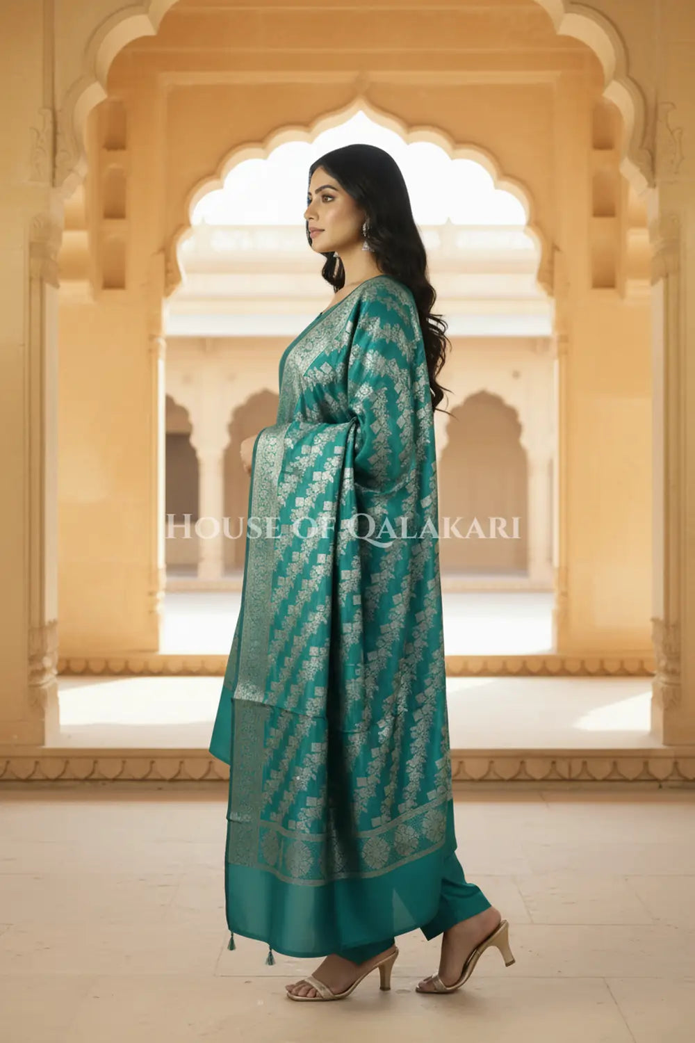 Banarasi silk Unstitched Dress Material in Emerald Green and with lotus floral border and diagonal striped zari work dupatta – side pose