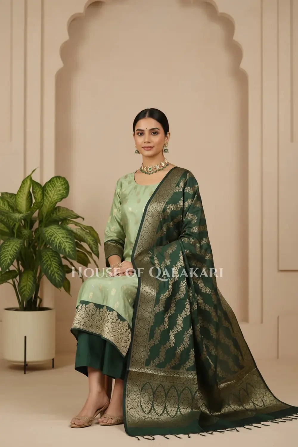 Banarasi Silk in pistachio green and bottle green contrast with Intricate Zari Buti – sitting pose