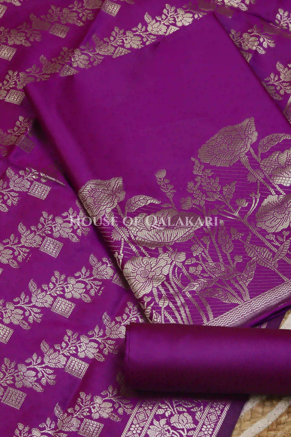 Banarasi silk Unstitched Dress Material in Rich Purple and with lotus floral border and diagonal striped zari work dupatta – product
