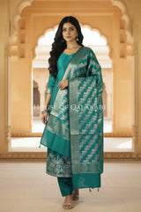 Banarasi silk Unstitched Dress Material in Emerald Green and with lotus floral border and diagonal striped zari work dupatta – front pose