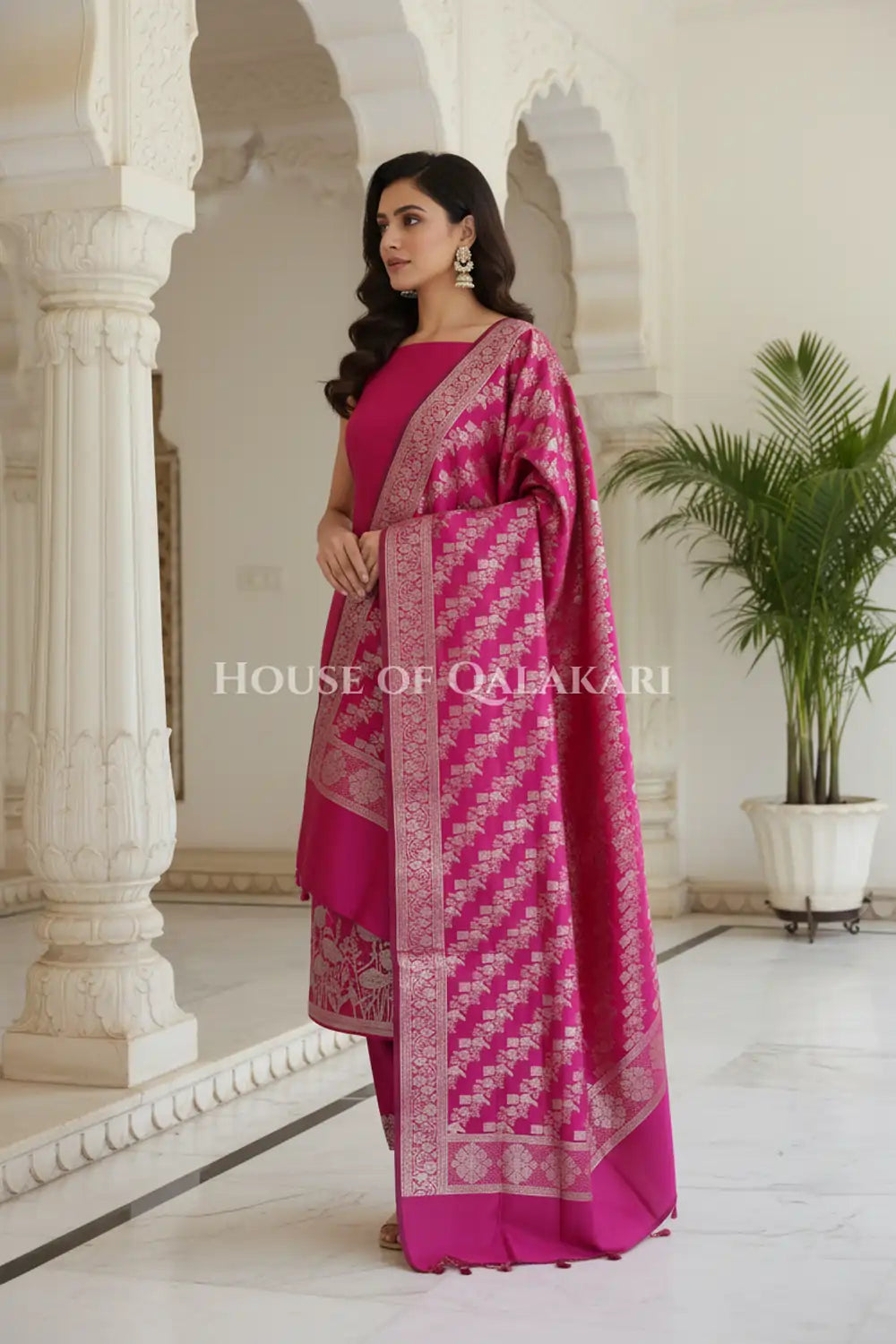 Banarasi silk Unstitched Dress Material in Rani Pink and with lotus floral border and diagonal striped zari work dupatta – side pose