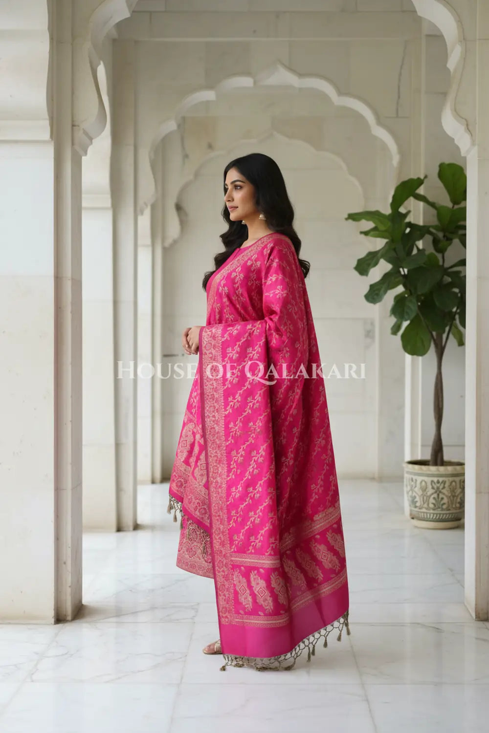 Banarasi Unstitched Dress Material in Rani Pink and with plain body and resham border and diagonally striped resham dupatta – side pose