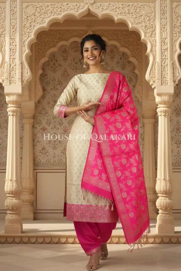 Banarasi Unstitched Dress Material in Mushroom and with all over leaf buti and resham border along with floral resham jaal dupatta – festive pose