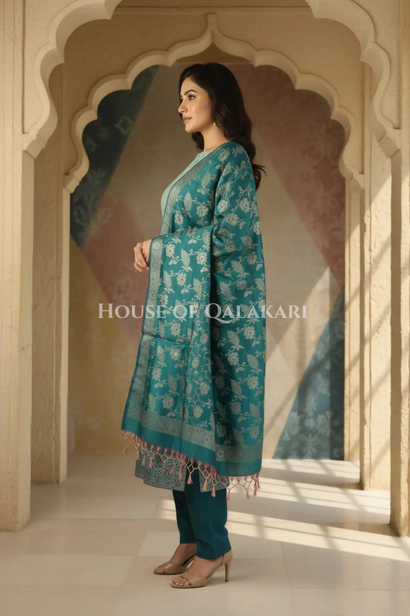Banarasi Unstitched Dress Material in Silver Green and with all over leaf buti and resham border along with floral resham jaal dupatta – side pose