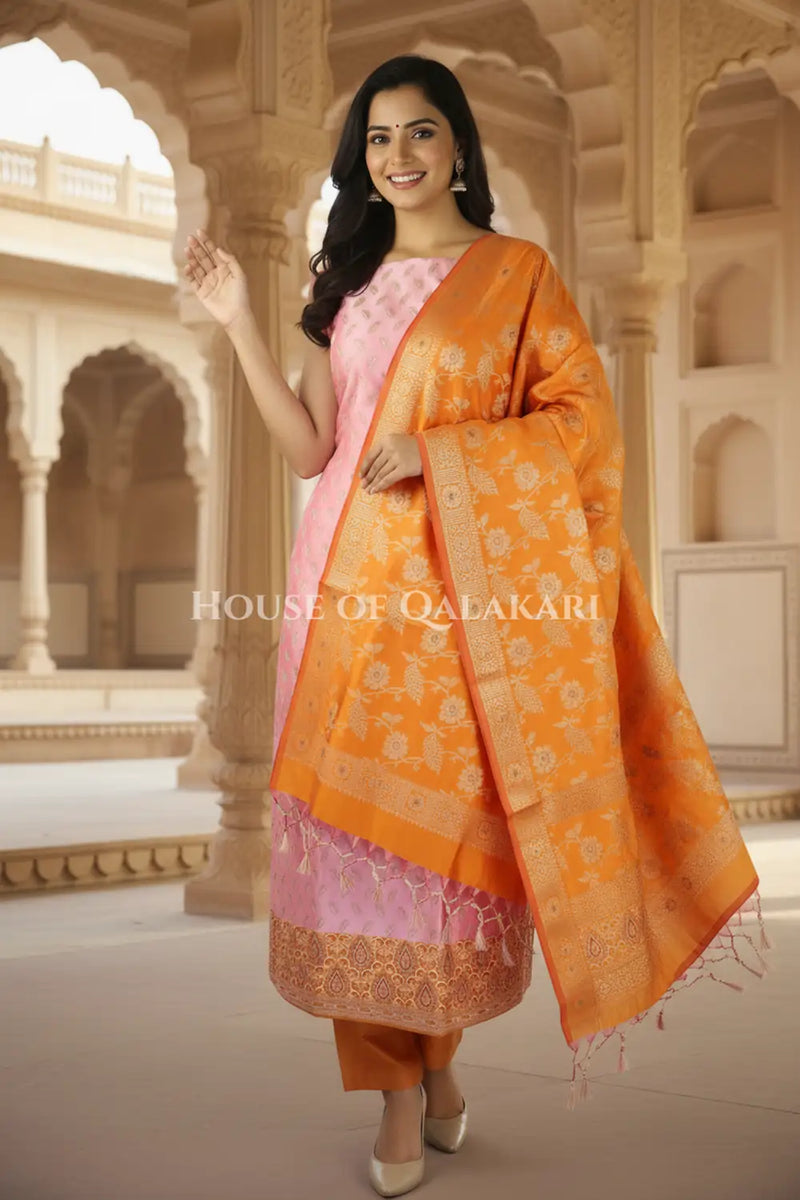 Banarasi Unstitched Dress Material in Dull Pink and with all over leaf buti and resham border along with floral resham jaal dupatta – festive pose