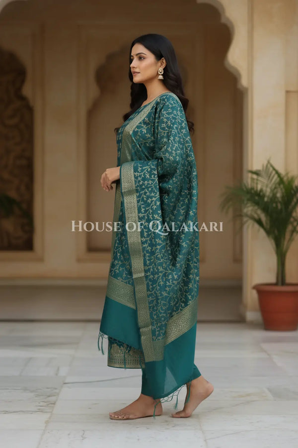 Banarasi Cotton Silk blend Unstitched Dress Material in Deep Teal Green and with matching floral vine jaal dupatta – side pose
